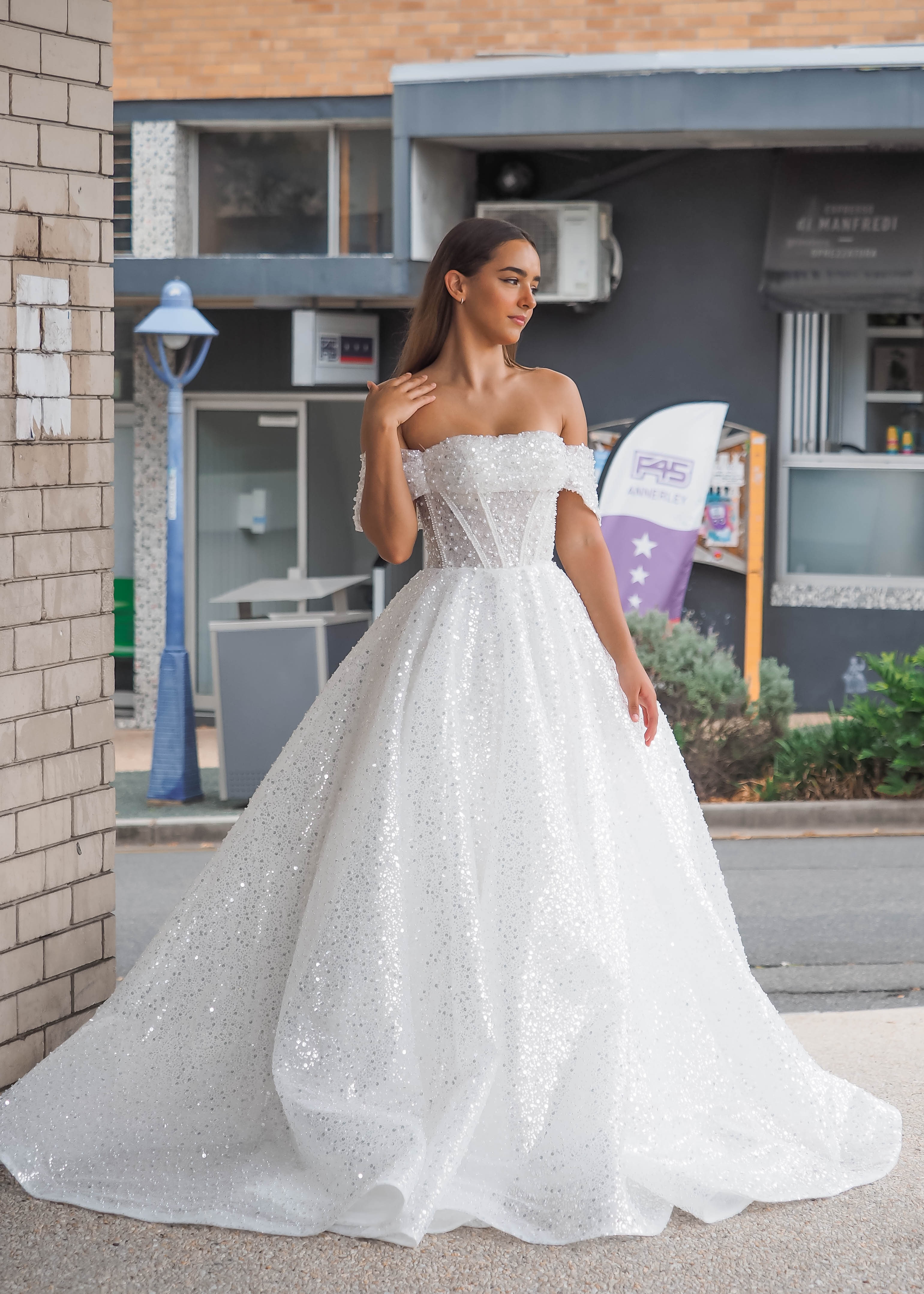 White sequins and beads all over the dress with off the shoulder sleev