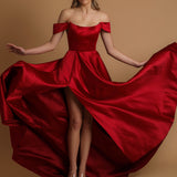 Red satin dress with off the shoulder and high slit